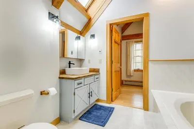 a bathroom with a white sink and a tub at Home 15 Mi to Berkshire East and Mount Snow! in Whitingham