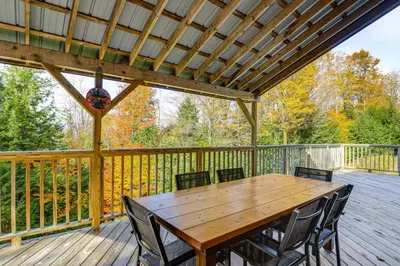 a wooden table and chairs on a deck at Home 15 Mi to Berkshire East and Mount Snow! in Whitingham
