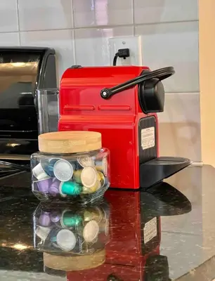a red toaster sitting next to a container of coins at Cozy apartment in New York in Woodside