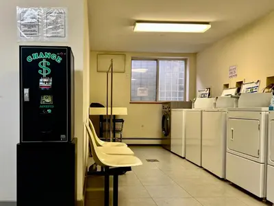 a waiting room with a chair and a cash machine at Cozy apartment in New York in Woodside