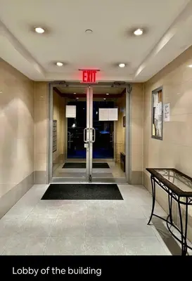 a lobby of a building with an exit sign on the door at Cozy apartment in New York in Woodside