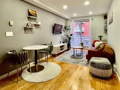 a living room with a couch and a table at Cozy apartment in New York in Woodside
