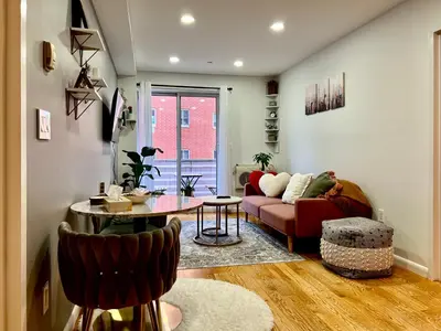 a living room with a couch and a table at Cozy apartment in New York in Woodside