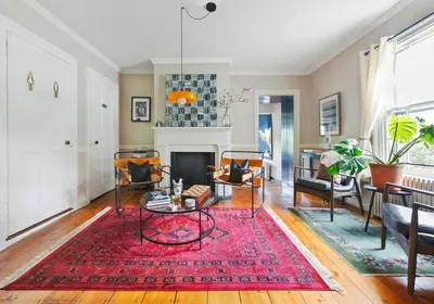 a living room with a fireplace and a red rug at Classic Country 6 Bedroom in Kingston