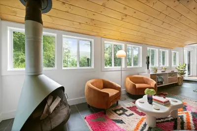 a living room with a wooden ceiling with windows at Classic Country 6 Bedroom in Kingston