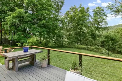 a wooden deck with a picnic table on top of it at Classic Country 6 Bedroom in Kingston