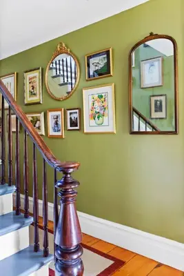a hallway with a staircase and a mirror on a wall at Classic Country 6 Bedroom in Kingston