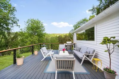 a deck with chairs and a couch and a table at Classic Country 6 Bedroom in Kingston