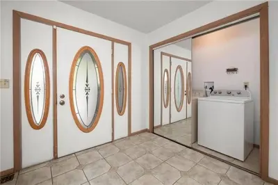 a laundry room with a washing machine and round windows at 5-Bedroom Lakefront, private beach wifi AC boat & in Tobyhanna