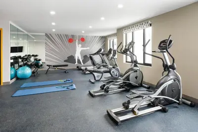 a gym with several treadmills and exercise bikes at GLō Best Western Bronx NYC in Bronx