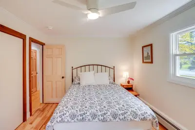 a bedroom with a bed and a window at 1 Mi to Dtwn Cottage with Large Yard in Stockbridge in Stockbridge