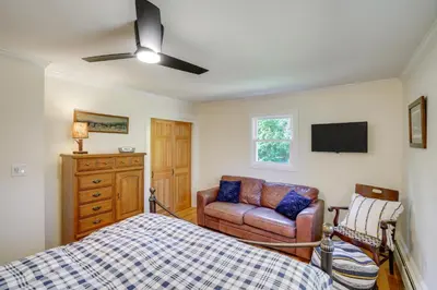 a bedroom with a bed and a couch and a tv at 1 Mi to Dtwn Cottage with Large Yard in Stockbridge in Stockbridge