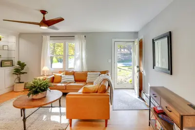 a living room with a couch and a table at 1 Mi to Dtwn Cottage with Large Yard in Stockbridge in Stockbridge