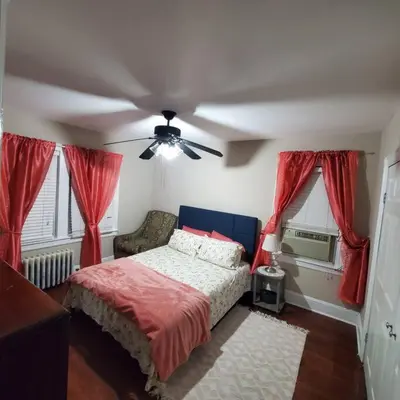 a bedroom with a bed and a ceiling fan at Adorable 2 Bedrooms in Bellerose NY in Bellerose