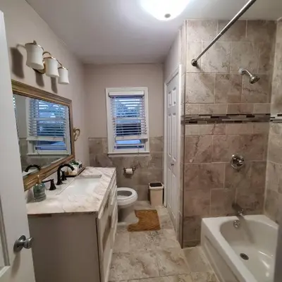 a bathroom with a sink and a toilet and a shower at Adorable 2 Bedrooms in Bellerose NY in Bellerose