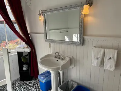 a bathroom with a sink and a mirror at Haslett House - A Gilded Age Estate in Fort Plain