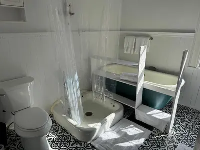 a white bathroom with a sink and a toilet at Haslett House - A Gilded Age Estate in Fort Plain