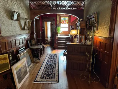 a hallway of a home with a room with wooden walls at Haslett House - A Gilded Age Estate in Fort Plain