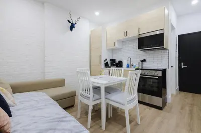 a kitchen and a living room with a table and chairs at 2 Bedroom Modern Unit in Central Manhattan in New York