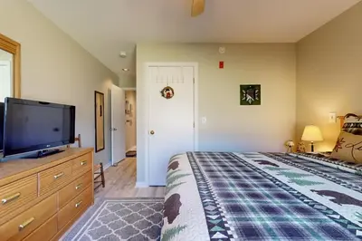 a bedroom with a bed and a flat screen tv at Snow Mountain Village 13F in Dover