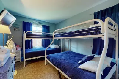 a bedroom with two bunk beds with blue walls at Snow Mountain Village 13F in Dover