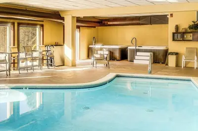 a pool at a hotel with chairs and tables at Snow Mountain Village 13F in Dover