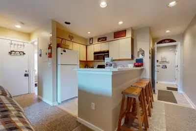 a kitchen with a counter and a refrigerator at Snow Mountain Village 13F in Dover