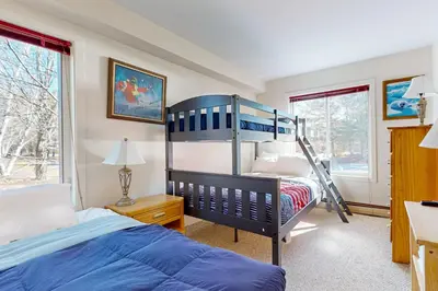a bedroom with a bunk bed and a ladder at Snow Mountain Village 13A in Dover