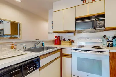 a kitchen with a sink and a stove at Snow Mountain Village 13A in Dover