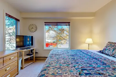 a bedroom with a bed and a tv and a window at Snow Mountain Village 13A in Dover