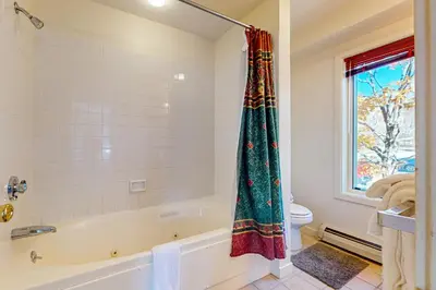 a bathroom with a tub and a window at Snow Mountain Village 13A in Dover