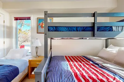a bedroom with two bunk beds and a window at Snow Mountain Village 13A in Dover