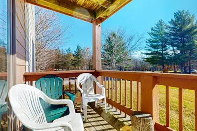two chairs sitting on the porch of a house at Snow Mountain Village 13A in Dover