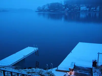 a dock on a body of water with a house at Falcon's Nest, Lakefront at Byram Cove, Hopatcong in Andover