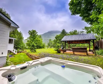 a hot tub in a yard with a gazebo at Hunter Hideaway with Hot Tub in Lanesville
