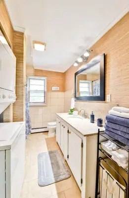 a bathroom with a sink and a toilet and a mirror at Hunter Hideaway with Hot Tub in Lanesville