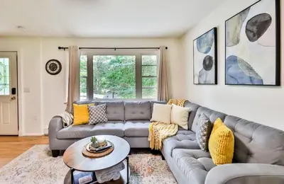 a living room with a couch and a table at Hunter Hideaway with Hot Tub in Lanesville