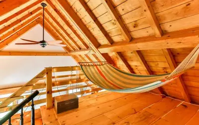 a hammock in a room with a wooden ceiling at Private Woodland Retreat with Cedar Hot Tub & Mt View in Gilboa