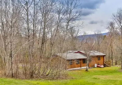 a log cabin in the middle of the woods at 4 Bedroom Log Cabin with Stream and Great Location in Lanesville