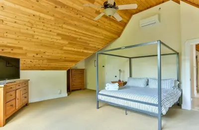 a bedroom with a bed and a wooden ceiling at Country Escape Overlooking Hunter & Windham Mts in Jewett