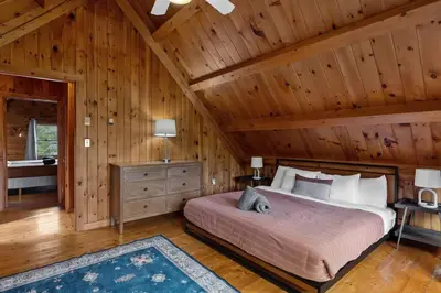 a bedroom with a bed and a wooden ceiling at Cozy Athens Cabin on the Lake with Hot Tub & Backyard in Athens