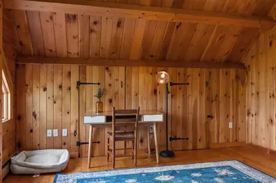 a room with a desk in a wooden wall at Cozy Athens Cabin on the Lake with Hot Tub & Backyard in Athens