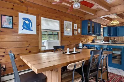 a dining room with a wooden table and chairs at Cozy Athens Cabin on the Lake with Hot Tub & Backyard in Athens