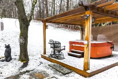 a gazebo in the snow next to a tree at Cozy Rustic Bliss Seconds from Windham Mt Resort in Windham