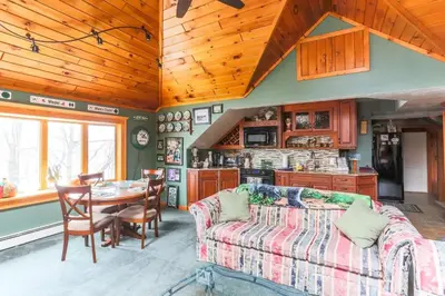 a living room with a couch and a table at Cozy Rustic Bliss Seconds from Windham Mt Resort in Windham