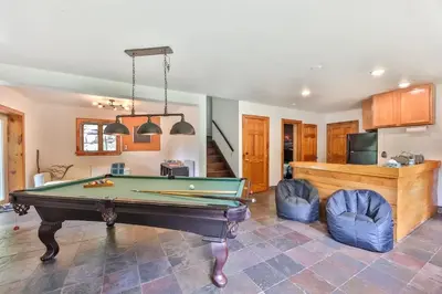 a living room with a pool table and two chairs at Dog-Friendly Mountain Hideaway in Jewett