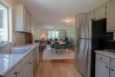 a kitchen with a refrigerator and a dining room at High Falls Hideout in Catskill