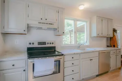 a kitchen with white cabinets and a stove top oven at High Falls Hideout in Catskill