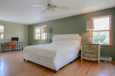 a bedroom with a bed and a table and a window at High Falls Hideout in Catskill