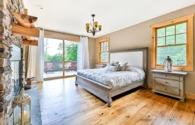 a bedroom with a bed and a fireplace at Luxurious Home & Amazing Views in Windham